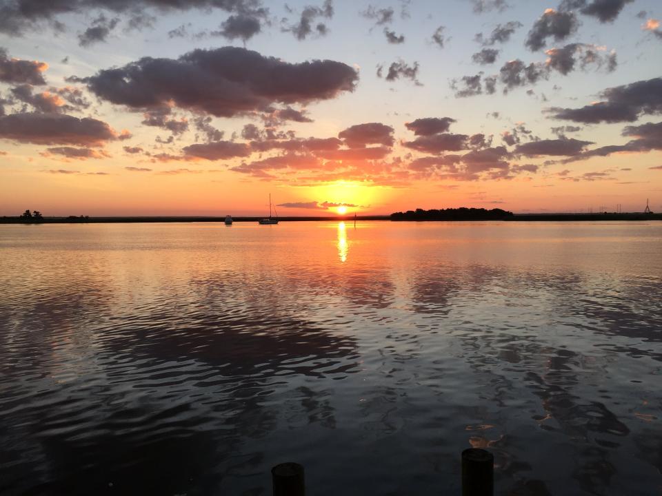 a sunset is shown over calm water 