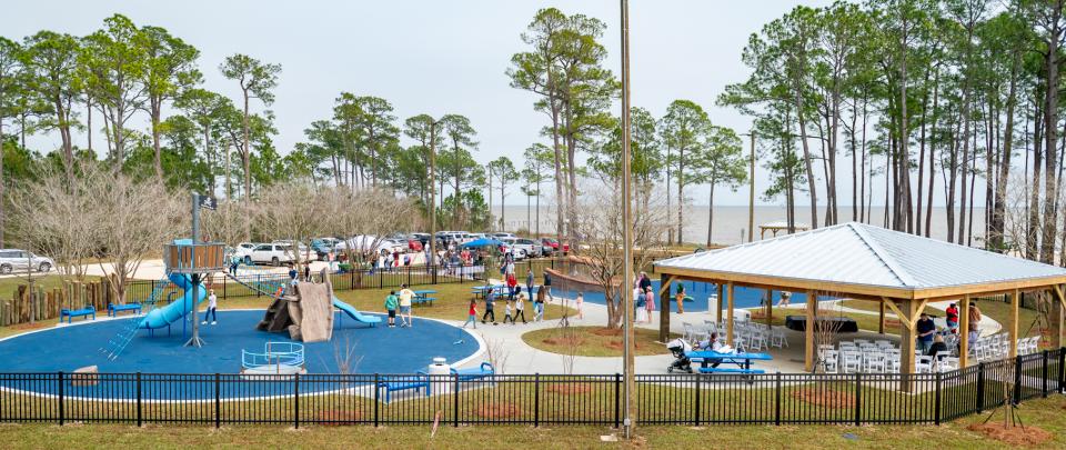 a kid's playground with people milling about