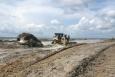 heavy machinery moved sand on a beach