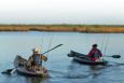 Two people fishing from kayaks