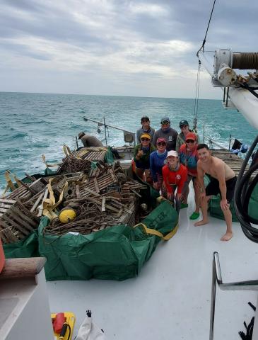 a group of men and women on a deck's boat 