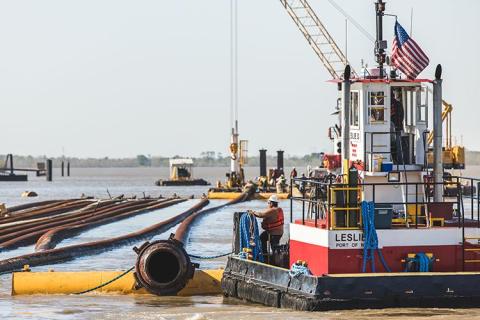Construction equipment and barge in marsh