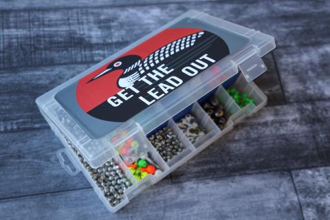 A small fishing tackle box with a sticker that says "Get the Lead Out."